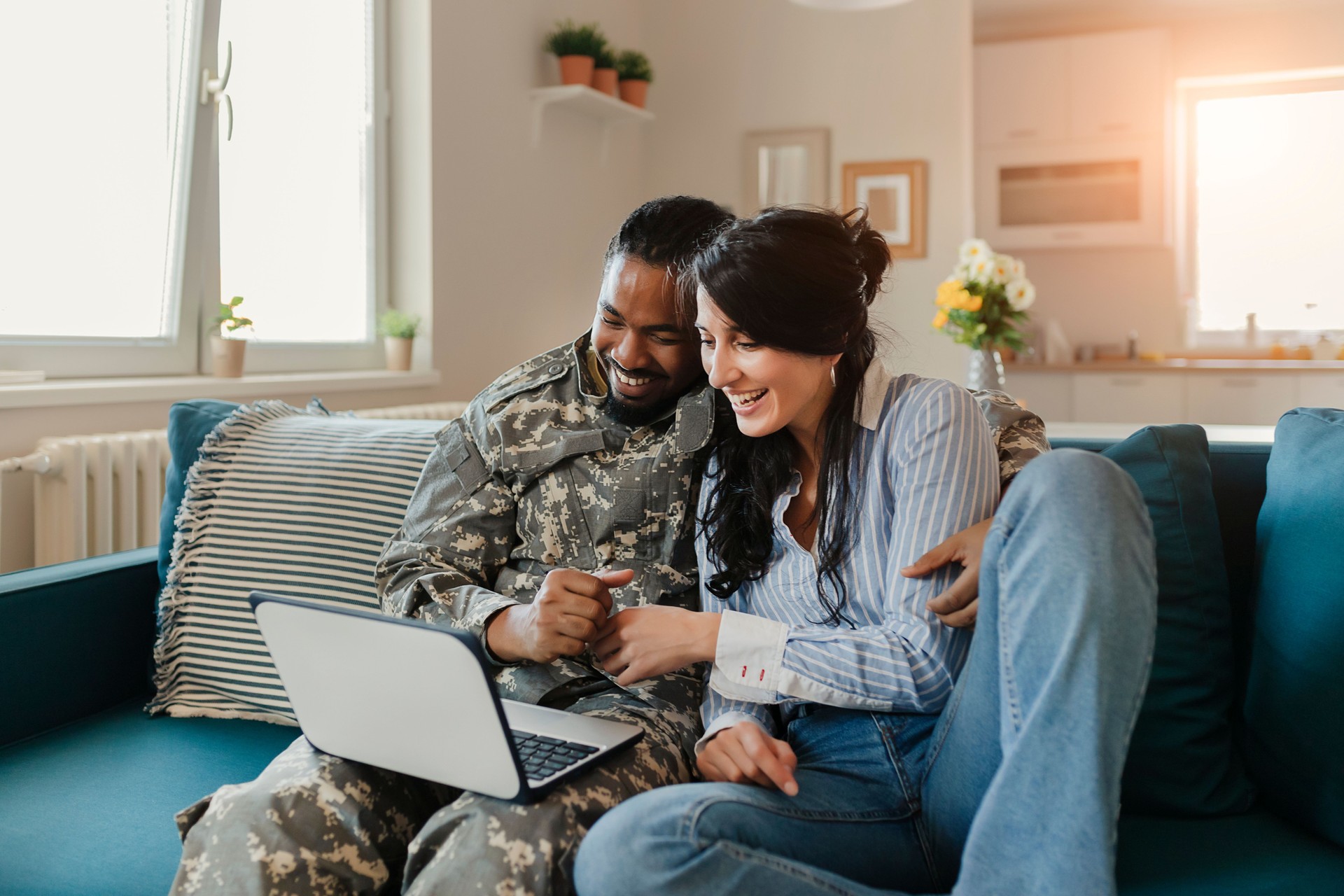 Male Soldier and His Wife using Laptop at Home